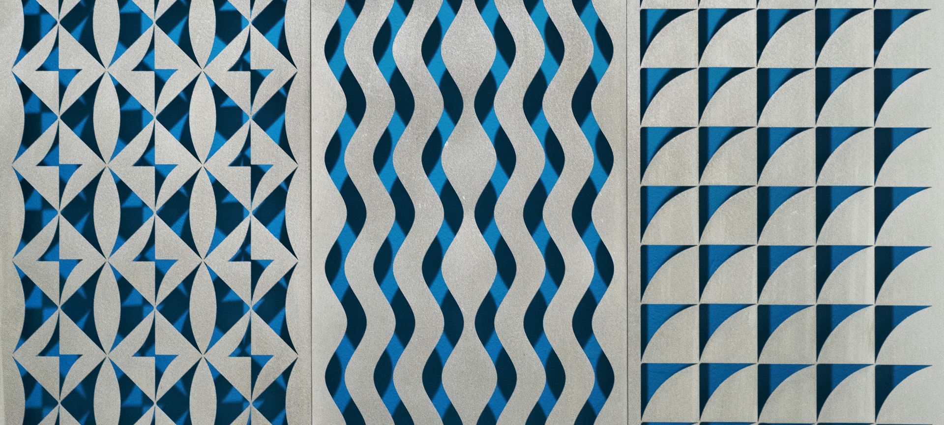 a painting of blue and white lines on a wall