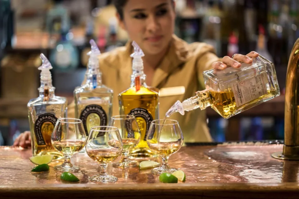 a woman pours a glass of white wine