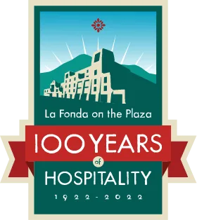A commemorative badge celebrating 100 years of hospitality at La Fonda, a historic Santa Fe hotel.