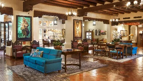 The richly decorated lobby area of the boutique hotel features New Mexican artwork and comfortable seating.