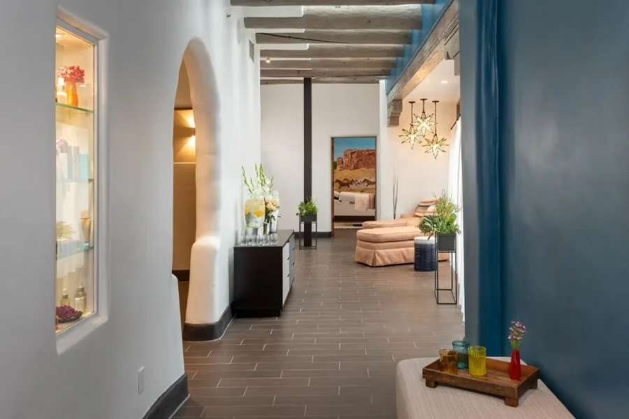 The relaxing lounge area of the hotel spa welcomes guests with comfortable seating and infused water.