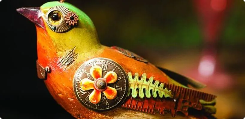 A brightly colored mechanical bird figurine is decorated with gears, clock faces, and intricate metal steampunk.