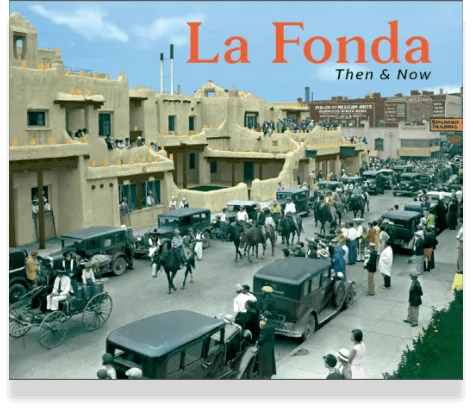A colorized historical photograph shows vintage cars and riders passing by the famous adobe hotel structure.