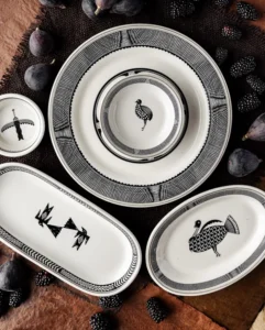 Several beautiful black and white Southwestern ceramic dishes are arranged with fresh figs and blackberries.