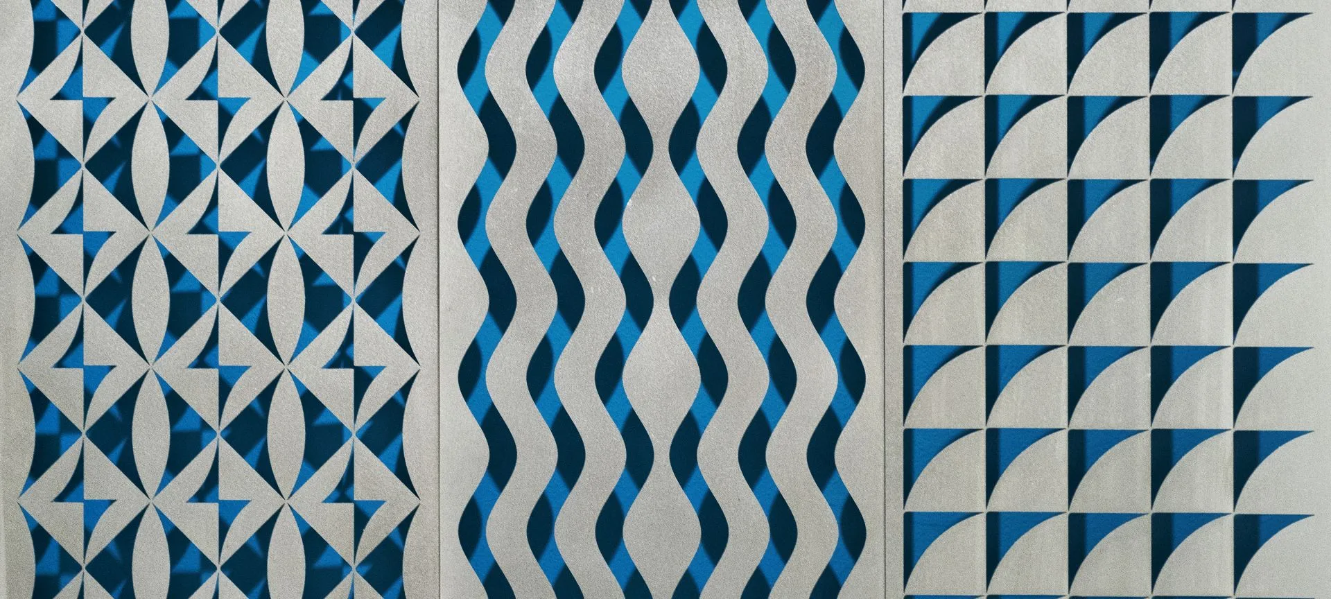 An abstract decorative panel features three vertical strips of repeating geometric patterns in blue and metallic silver.