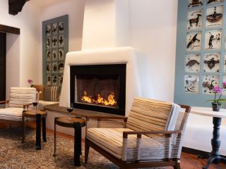 A Room With A Fireplace And Chairs