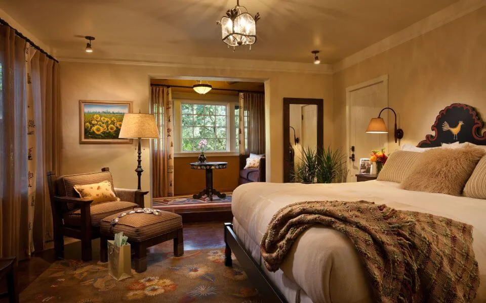 This inviting boutique hotel room features Southwestern style decor, including a king bed and a comfortable reading.