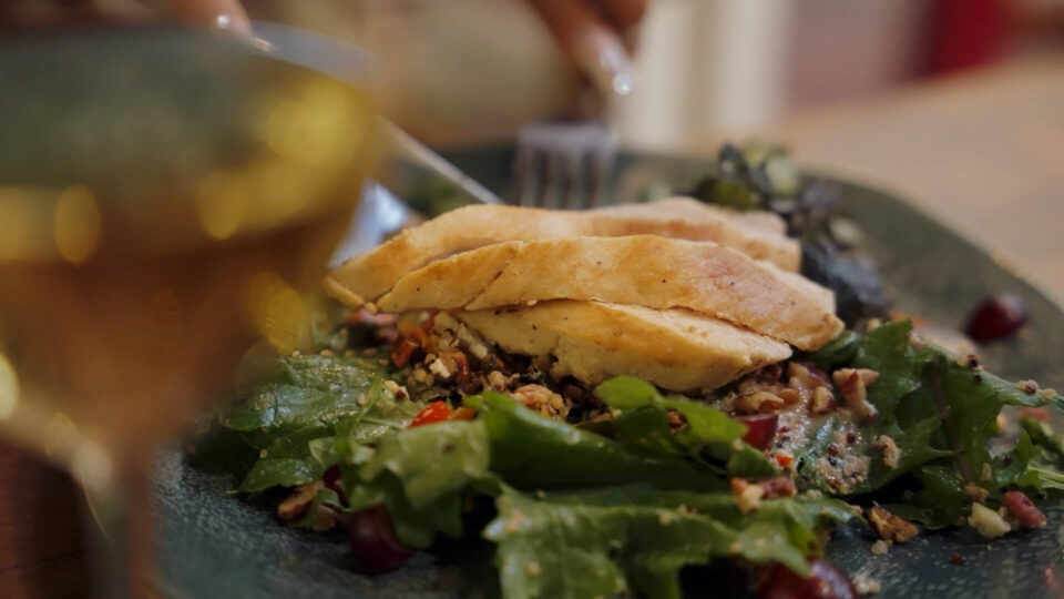 A diner enjoys a fresh chicken salad with nuts and grapes at one of the area's popular restaurants.