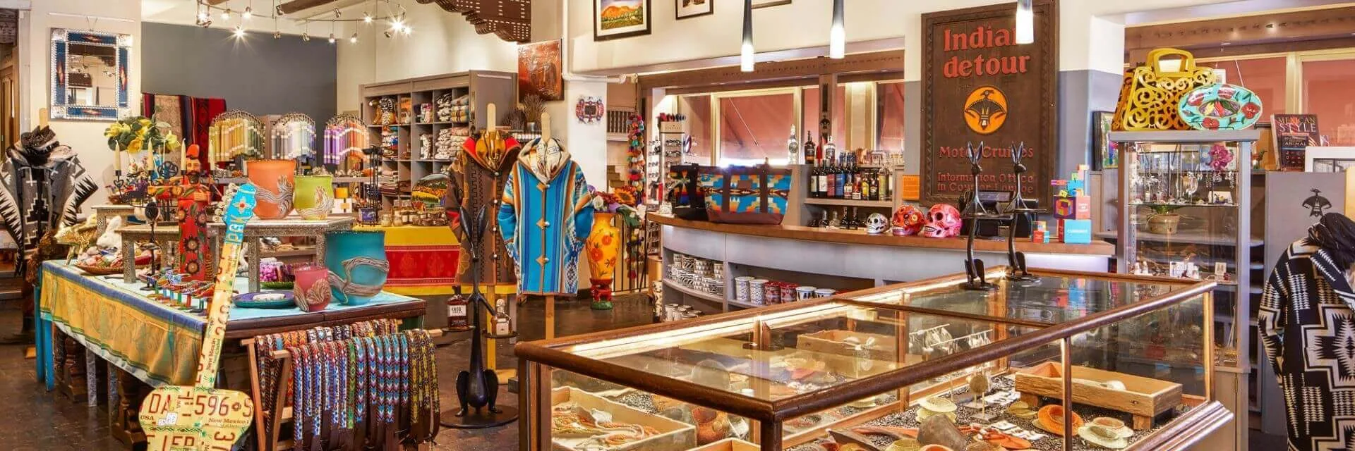 Display cases filled with Southwestern-style jewelry, colorful pottery, and vibrant patterned textiles inside the.