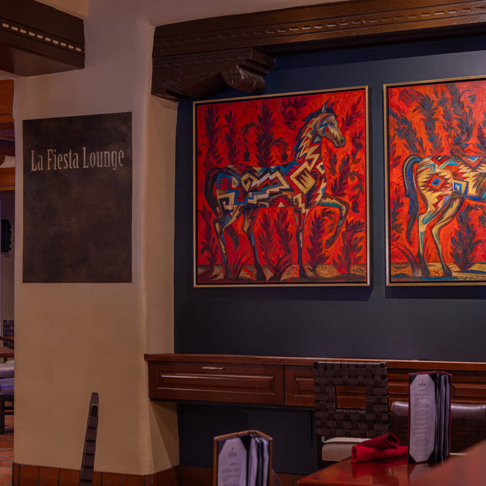The lively Southwestern-style lounge, suitable for live music, features two vibrant horse paintings.