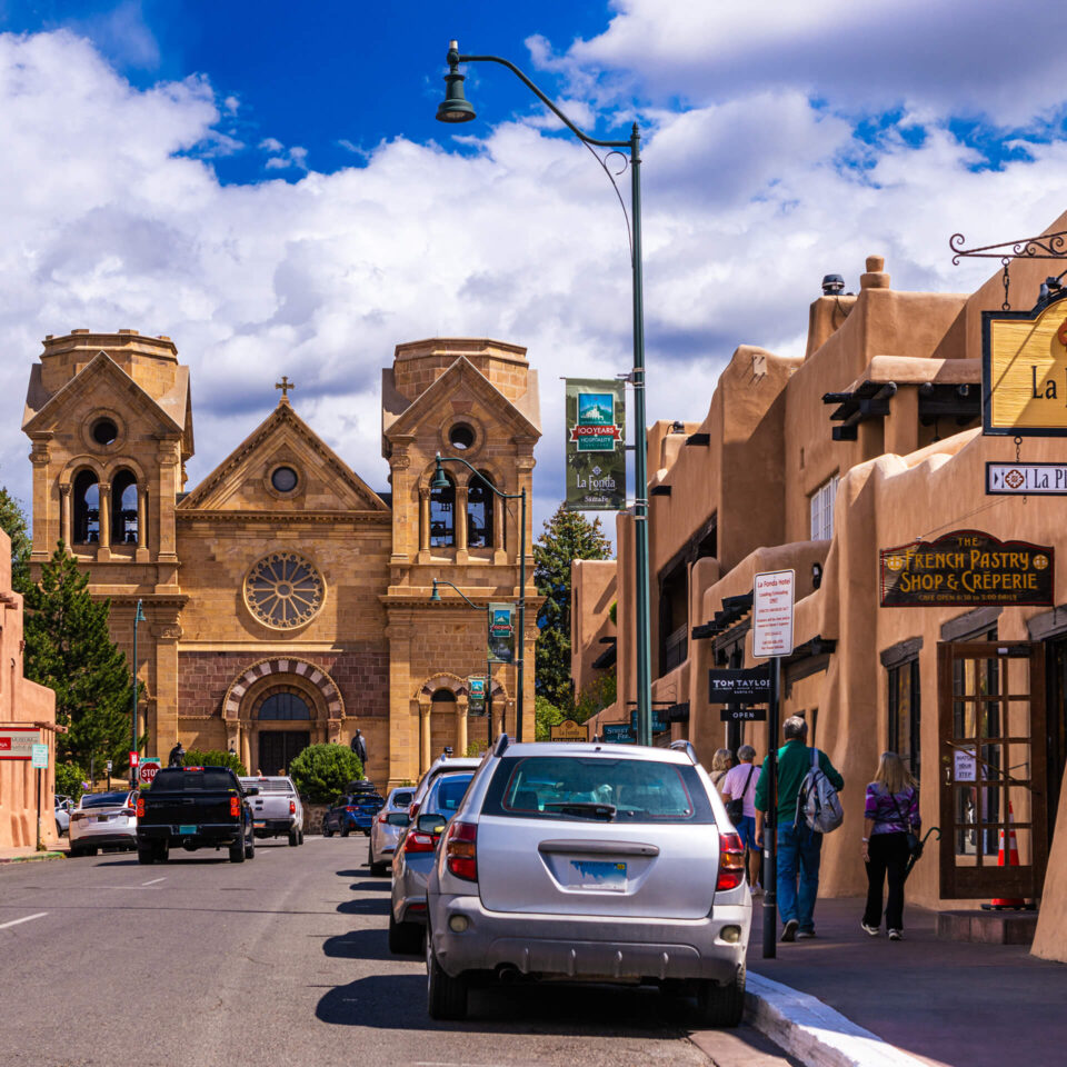 The St. Francis Cathedral Basilica towers over the historic Pueblo Revival architecture lining the downtown street.