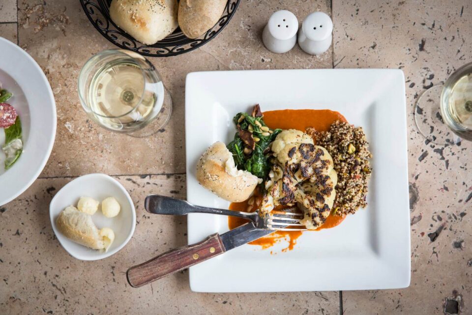An artistic plate featuring a roasted cauliflower steak is served at one of the downtown Santa Fe restaurants.