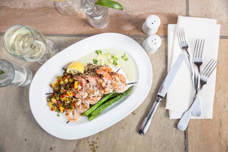 A beautiful overhead view of a grilled shrimp and asparagus plate served at one of the fine dining restaurants in Santa.