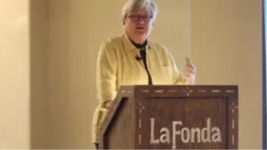 A speaker addresses the audience from the podium in one of the professional event spaces.