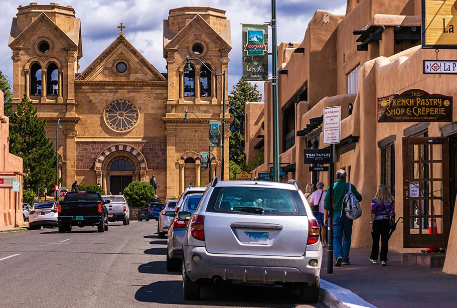 The stone facade of the historic Basilica overlooks the street lined with adobe buildings housing downtown restaurants.