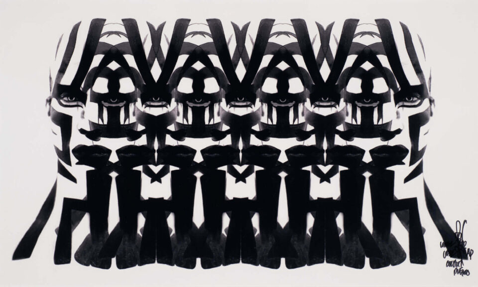 A striking black and white abstract print shows a symmetrical pattern of repeated, stylized human faces and figures.