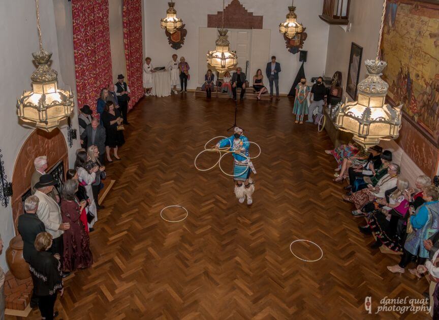 Guests watch a cultural performance by a hoop dancer in the beautiful, ornate hotel ballroom.