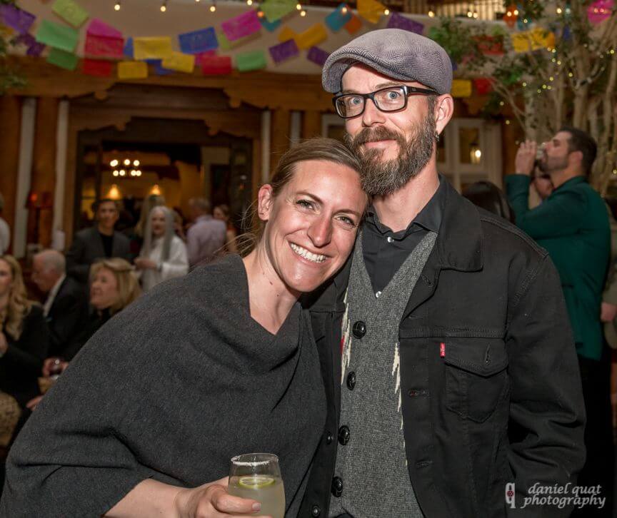 A happy couple poses at a social gathering in the beautifully decorated hotel event spaces.