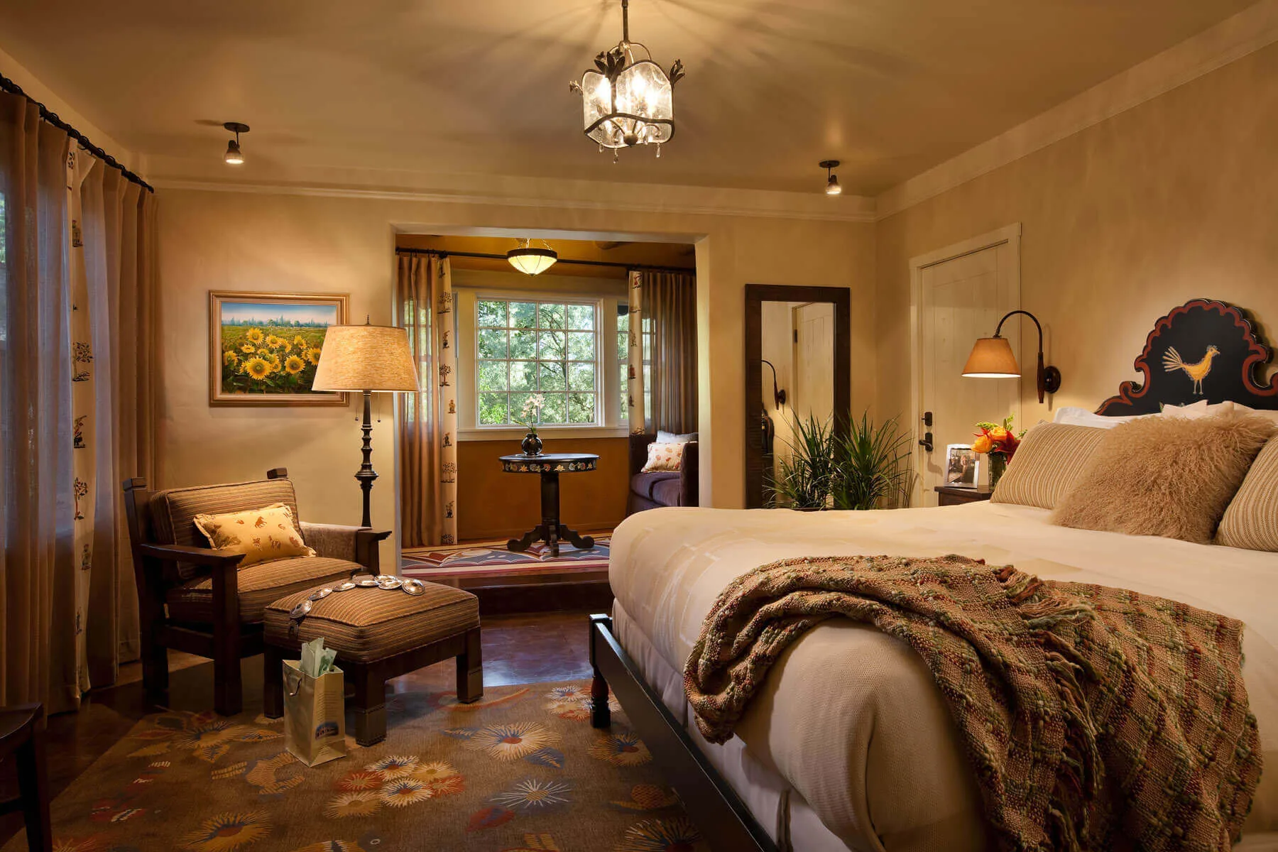 This luxurious king-sized hotel suite features custom Southwestern decor, soft lighting, and a comfortable window.