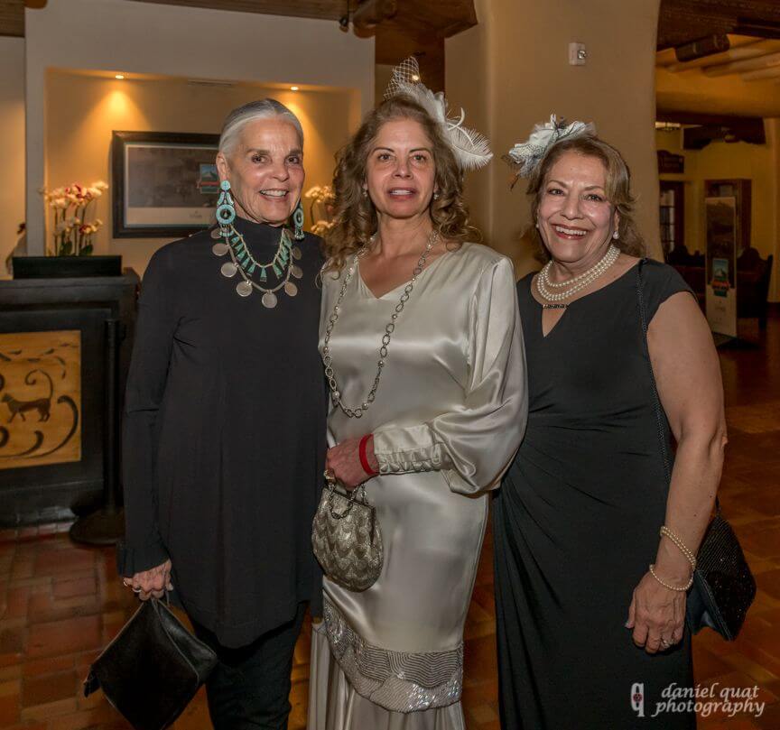 Three elegantly dressed women enjoy the atmosphere of the hotel's spacious event spaces.