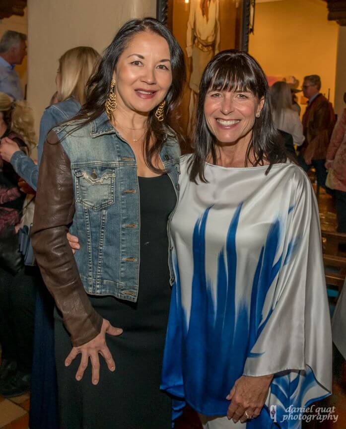 Two smiling women pose for a picture during an elegant evening reception at the event spaces.