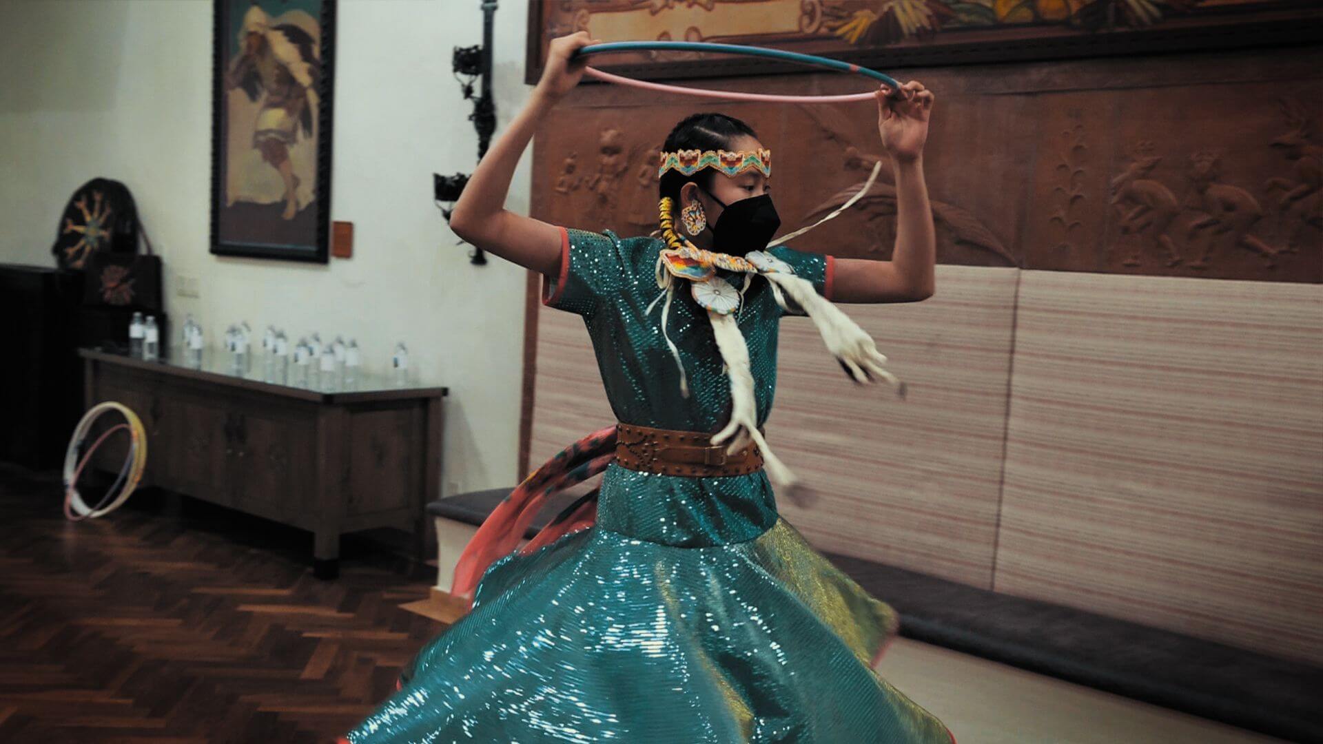 A young hoop dancer performs a traditional routine, providing live cultural entertainment in the hotel's event spaces.