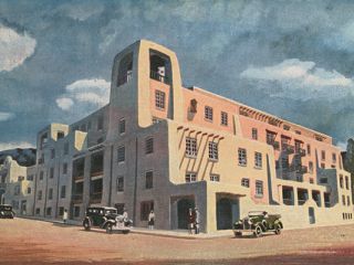 A Building With Cars Parked In Front