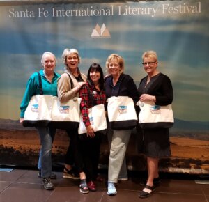 literary festival - 5 women holding white canvas bags