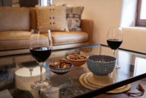 wine glasses and nuts on a glass table.